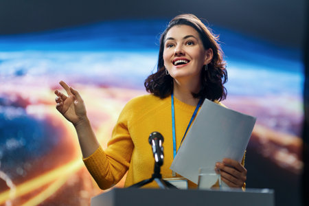 A young woman is giving a presentation at a conference.の写真素材
