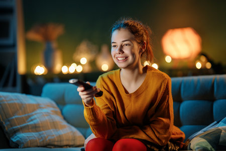 Young woman watching TV at home.