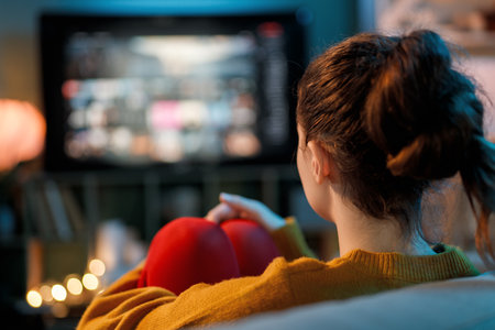 Young woman watching TV at home.の写真素材