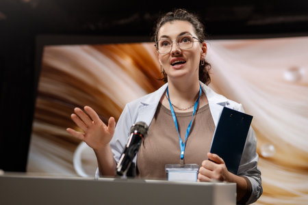 A woman is giving a presentation at a conference on care products.の写真素材