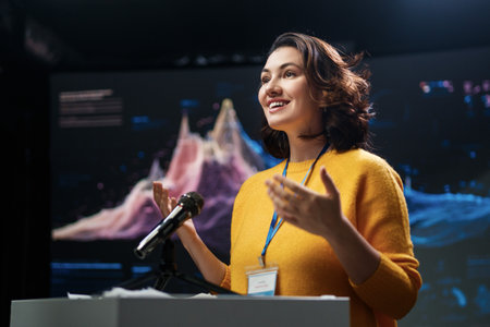 A young woman is giving a presentation at a conference.の写真素材