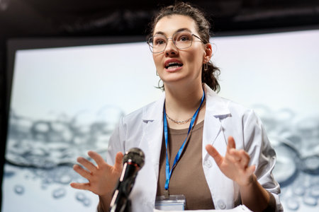 A woman is giving a presentation at a conference on care products.の写真素材