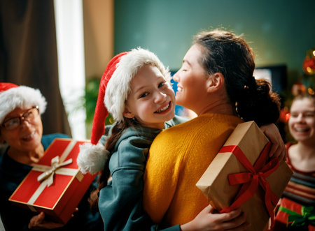 Merry Christmas and Happy Holidays. Grandma, mum and children exchanging gifts. Parents and daughters having fun near tree indoors. Loving family with presents in room.の写真素材