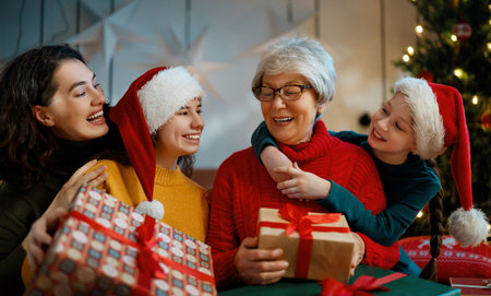Merry Christmas and Happy Holidays. Grandma, mum and children exchanging gifts. Parents and...