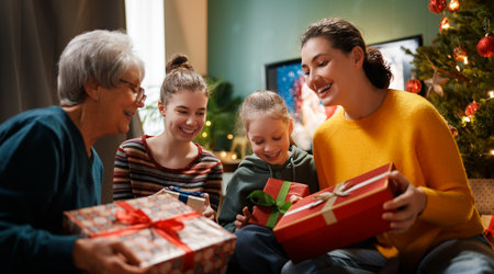 Merry Christmas and Happy Holidays. Grandma, mum and children exchanging gifts. Parents and...