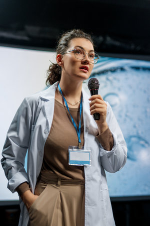 A woman is giving a presentation at a conference on care products.の写真素材