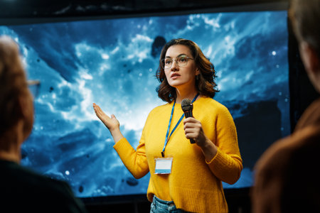 A young woman is giving a presentation at a conference.