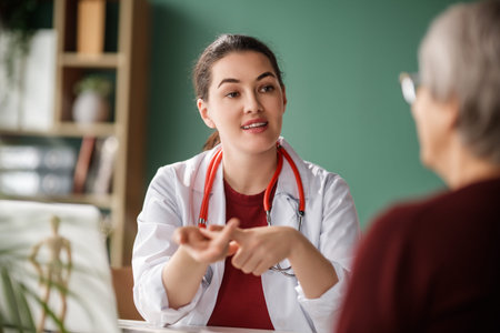 Female patient listening to a doctor in hospital.の写真素材