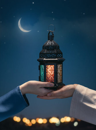 Ornamental Arabic lantern with burning candle glowing in hand. Festive greeting card, invitation for...