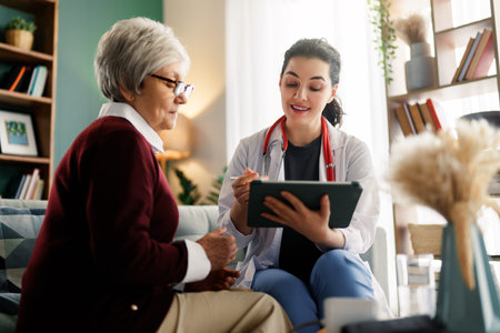 Female patient talking with a doctor indoors.の写真素材