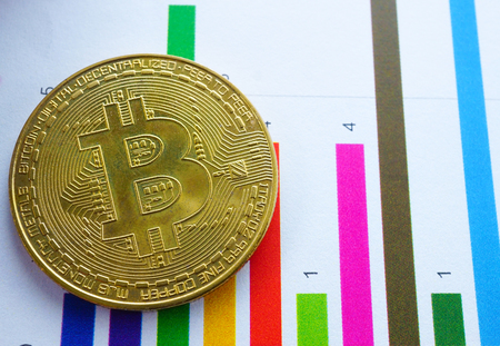 A golden bitcoin on graph background. Finance Electronic Technology Account, Statistics, Investment...