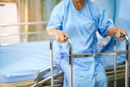 Asian senior or elderly old lady woman patient walk with walker at nursing hospital ward : healthy strong medical conceptの写真素材