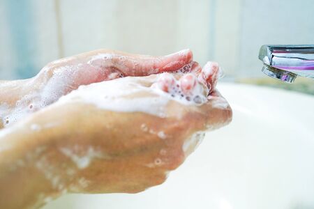 Asian middle-aged lady woman patient washing hands in the hospital ward : healthy medical conceptの写真素材