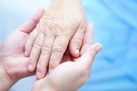 Holding Touching hands Asian senior or elderly old lady woman patient with love, care, helping,...