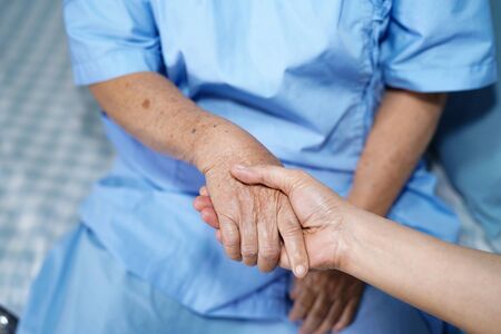 Holding Touching hands Asian senior or elderly old lady woman patient with love, care, helping,...