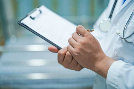 Doctor with clipboard  for note diagnosis  of patients in nursing hospital ward : healthy strong medical concept.の写真素材