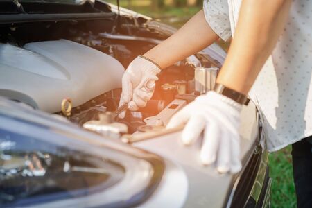 Open hood mechanic engine system to check and repair damage car crash.の写真素材