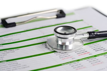 Stethoscope on spreadsheet paper, Finance, Account, Statistics, Investment, Analytic research data economy spreadsheet and Business company concept.の写真素材