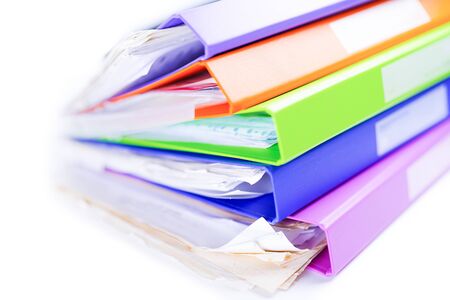 File Folder Binder stack of multi color on table in office.