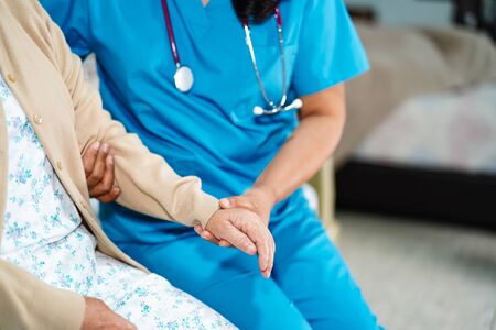 Asian nurse physiotherapist doctor care, help and support senior or elderly old lady woman patient...