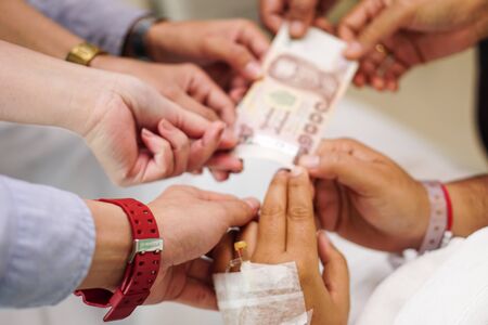 Hands of male and female holding banknote to philanthropy, donate and charity.