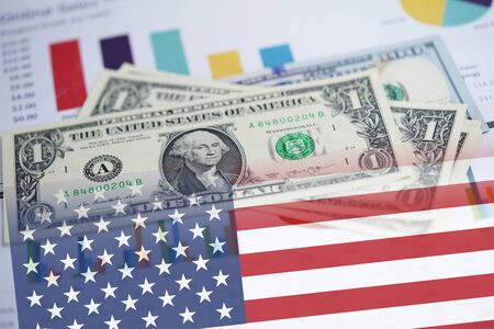 US dollar banknotes money on chart graph spreadsheet paper with USA America Flag. Financial development, Banking Account, Statistics, Investment Analytic research data economy, trading, office reporting Business company meeting concept.の写真素材