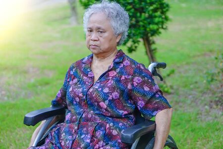 Asian senior or elderly old lady woman patient on wheelchair in park : healthy strong medical concept 
の写真素材