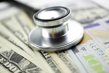 Stethoscope on US dollar banknotes, Finance, Account, Statistics, Analytic research data and...