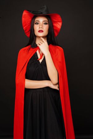 Asian beautiful woman in witches hat and costume in halloween festival.の写真素材