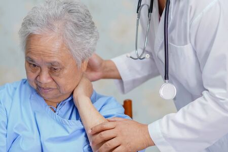 Asian senior or elderly old lady woman patient neck pain while sitting  in nursing hospital ward : healthy strong medical conceptの写真素材