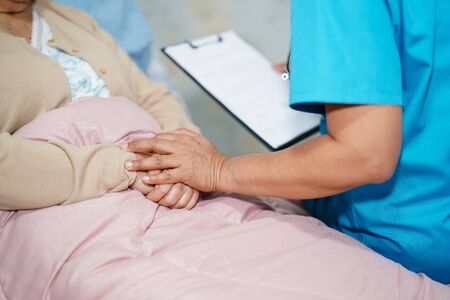 Asian nurse physiotherapist doctor care, help and support senior or elderly old lady woman patient at hospital ward : healthy strong medical concept.の写真素材
