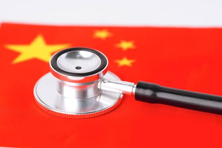 Black stethoscope on China flag background : Business and finance concept.の写真素材