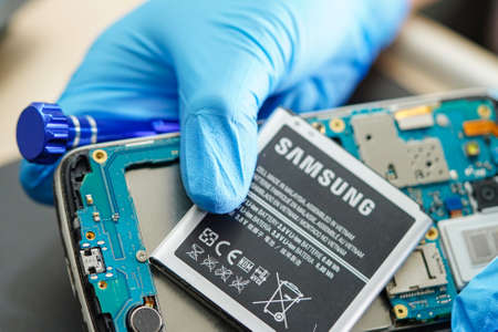 BANGKOK,THAILAND. FEBRUARY 1,2020: Technical holding battery for Smartphone SAMSUNG.