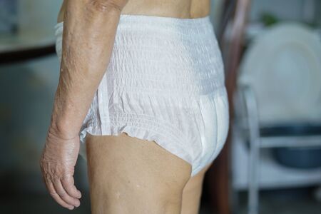 Asian senior or elderly old lady woman patient wearing incontinence diaper in nursing hospital ward : healthy strong medical concept.の写真素材