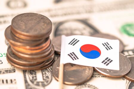 Stack of coins with South Korea flag on USA America dollar banknotes.の写真素材