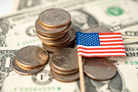 Stack of coins with USA America flag on dollar banknotes.の写真素材