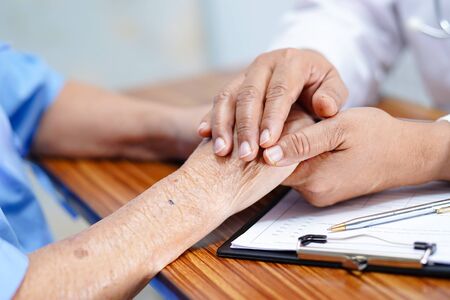 Holding Touching hands Asian senior or elderly old lady woman patient with love, care, helping, encourage and empathy at nursing hospital ward : healthy strong medical concept の写真素材