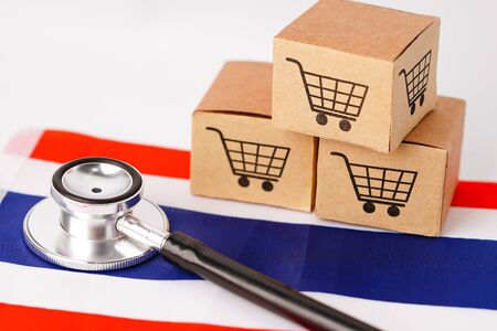 Box with shopping cart logo and stethoscope on Thailand flag : Import Export Shopping online or eCommerce finance delivery service store product shipping, trade, supplier concept.の写真素材