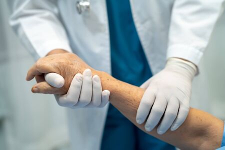 Doctor holding touching hands Asian senior or elderly old lady woman patient with love, care,...