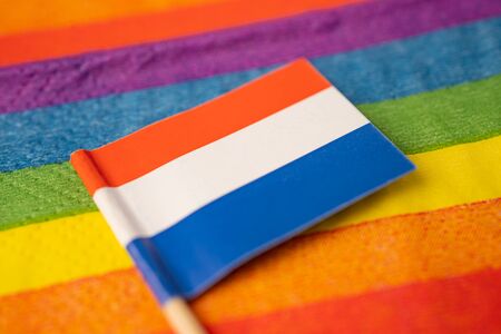 Netherlands flag on rainbow background symbol of LGBT gay pride month  social movement rainbow flag is a symbol of lesbian, gay, bisexual, transgender, human rights, tolerance and peace.の写真素材