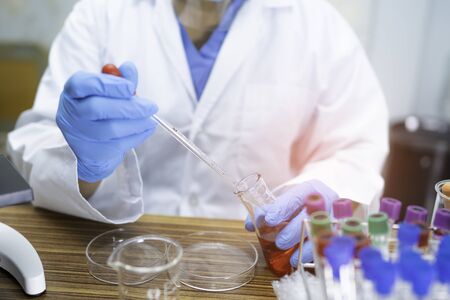Asian scientist biochemist or microbiologist working research in laboratory. For protect outbreak...