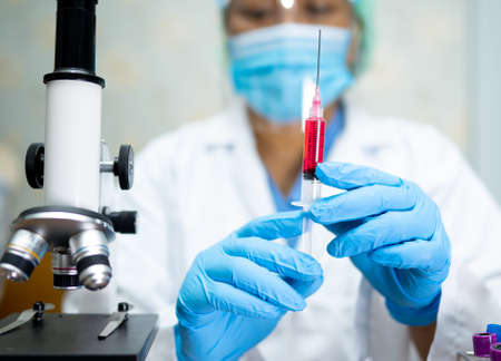 Doctor holding syringe with vaccine development medical for doctor use to treat illness patients...