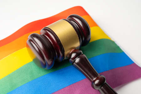 Gavel for judge lawyer on rainbow flag, symbol of LGBT pride month celebrate annual in June social...