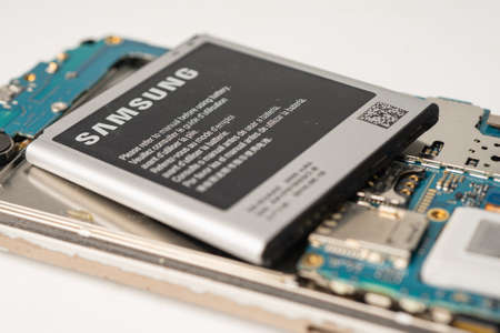BANGKOK,THAILAND.JULY 1,2020 technician repairing and insert battery for Smartphone SAMSUNG.のeditorial素材