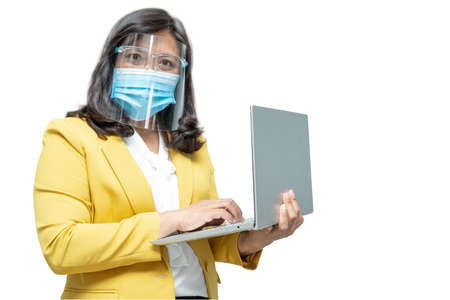 Asian business women use laptop notebook wearing mask and face shield on white