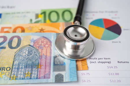 Stethoscope and Euro banknotes on chart or graph paper, Financial, account, statistics and business data  medical health concept.の写真素材