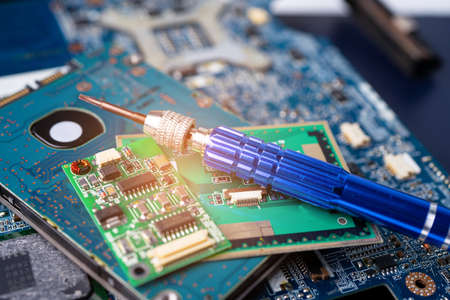 Screwdriver on the computer main board hardware. Repair upgrade and maintenance technology.