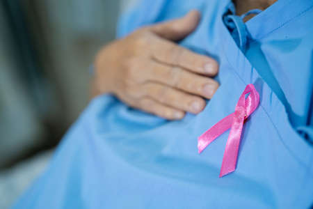 Breast cancer, pink ribbon at Asian senior lady patient for supporting awareness.の写真素材