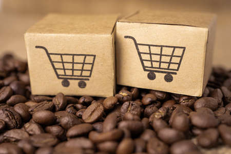 Box with shopping cart logo symbol on coffee beans, Import Export Shopping online or eCommerce delivery service store product shipping, trade, supplier concept.の写真素材
