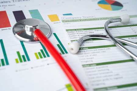 Stethoscope on charts and graphs spreadsheet paper, Finance, Account, Statistics, Investment,...